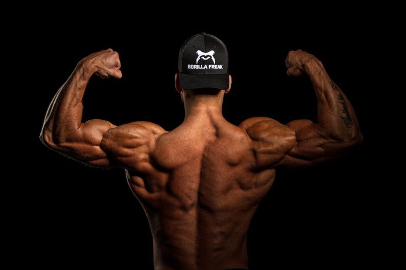 Bodybuilding - topless man wearing black and white cap