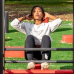 Low-Impact Cardio - woman in white long sleeve shirt and black pants sitting on red metal frame