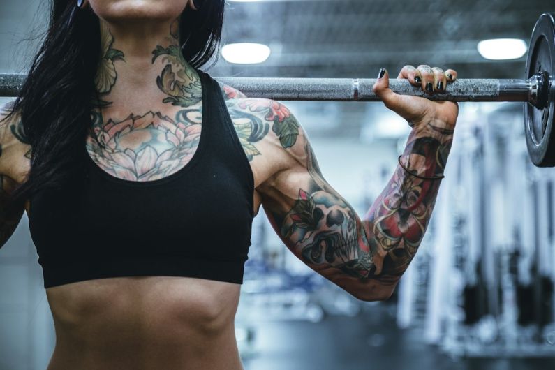 Body Type Fitness - woman carrying barbell