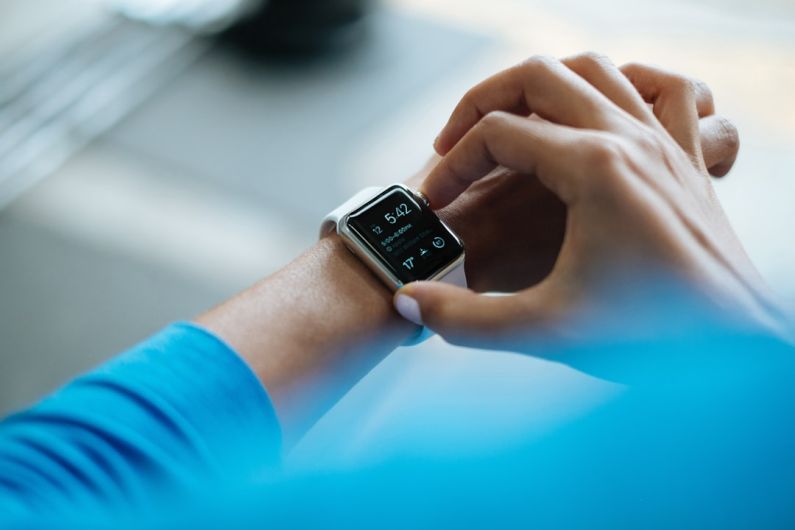 Tracker Wristband - person clicking Apple Watch smartwatch