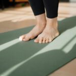 Yoga Mat - a person standing on a yoga mat on the floor