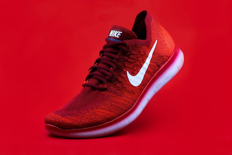 Running Shoes - unpaired red Nike sneaker