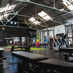 CrossFit Gym - people in a room with a black table and chairs