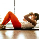 Motivation Fitness - woman exercising indoors