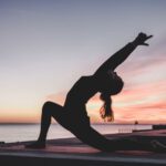Stretching Exercise - silhouette photography of woman doing yoga