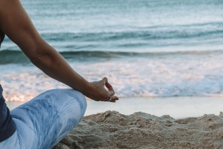 Mindfulness Exercise - person in blue shorts sitting on beach shore during daytime